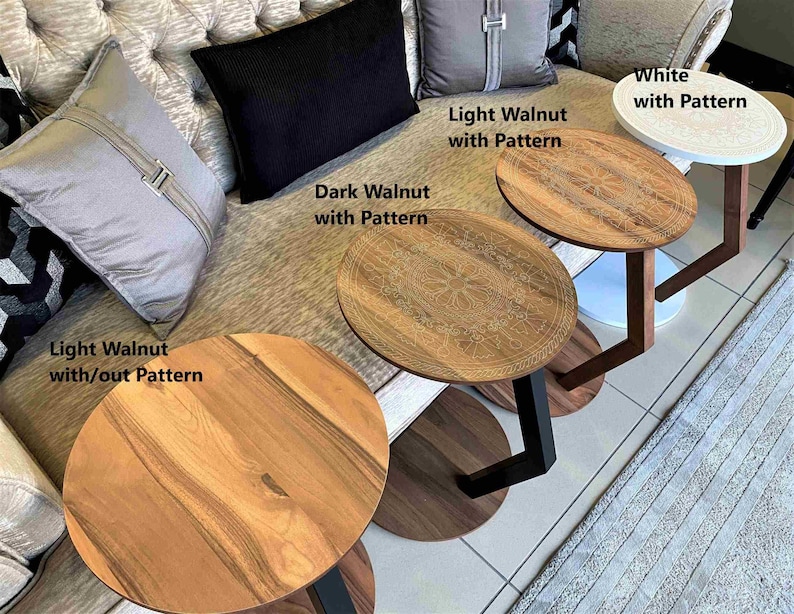 May include: Several small, round accent tables with wooden tops and different base designs. The tables are labelled "Light Walnut with/out Pattern", "Dark Walnut with Pattern", "Light Walnut with Pattern", and "White with Pattern".
