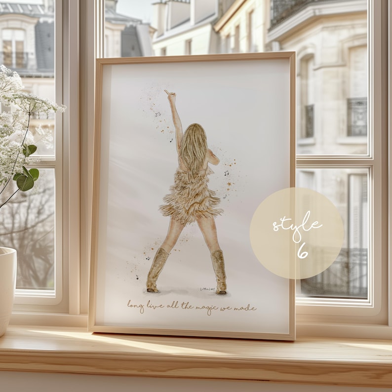 May include: Watercolor print in a wooden frame. The artwork depicts a singer on stage with long blonde hair, wearing a fringed dress and boots. The text "long live all the magic we made" is at the bottom.