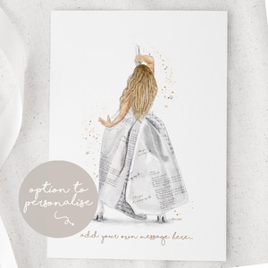 May include: A white ceramic mug with a black handle and the text "But First, Coffee" in a bold, black font. The mug is set against a blurred background, suggesting a cosy setting.