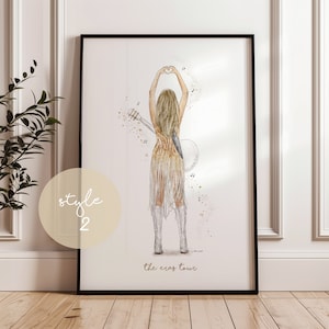 May include: A framed art print featuring a watercolor illustration of a performer from the back, wearing a gold fringed dress and silver boots, holding a guitar, with hands forming a heart shape. The text reads style 2 and the eras tour.