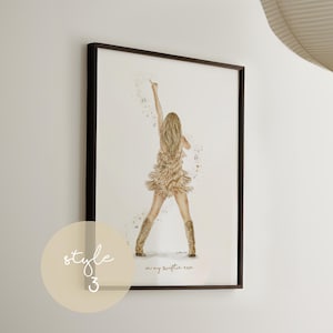 May include: Framed art print featuring a watercolor illustration of a person on stage, wearing a fringed dress and boots, with their arm raised. The print includes the text "in my swiftie era" and is framed in a black frame. A light beige circle with the text "style 3" is in the lower left corner.