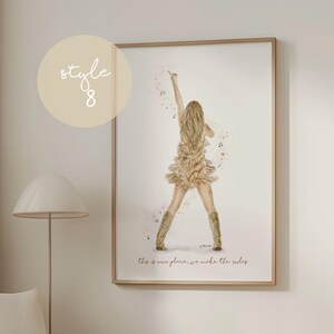 May include: Watercolor print of a woman in a fringed dress and boots, raising an arm. The artwork is in a wooden frame, with the text "this is our place, we make the rules" at the bottom. A light beige circle with the text "style 8" is in the upper left.