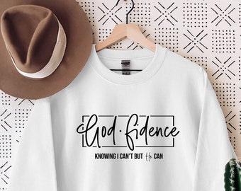 Może przedstawiać: Biała bluza z czarnym napisem "God-fidence Knowing I can't but He can".