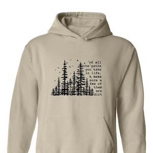 a white hoodie with trees and a quote on it