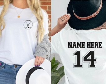 May include: Two white t-shirts, one with a hockey stick graphic and the text "Team Name" and the other with the text "Name Here" and the number "14" in a black and white athletic font.