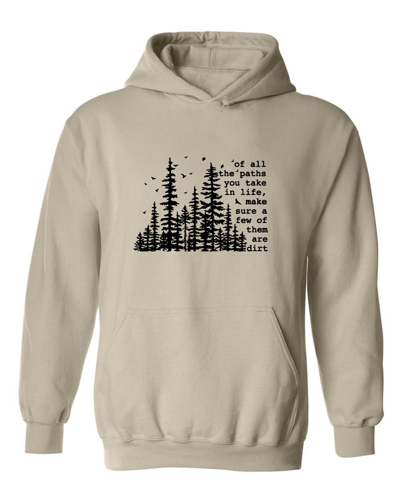a white hoodie with trees and a quote on it