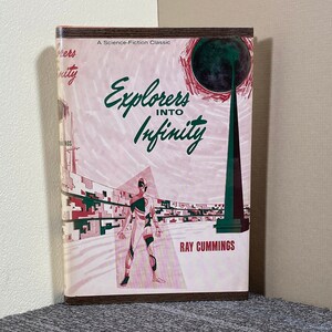 May include: A vintage paperback book cover with a pink and green illustration of a futuristic city. The title is "Explorers Into Infinity" by Ray Cummings. The book is a science fiction classic.