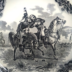 May include: A black and white illustration of a historical scene depicting a man on horseback being attacked by another man on horseback. The scene is titled "Mort de Desaix a Marengo 14 Juin 1800".