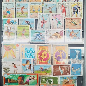 May include: A collection of vintage postage stamps featuring Olympic sports from various countries, including Vietnam, Cambodia, Laos, and Guinea Equatorial. The stamps depict athletes competing in sports such as skiing, swimming, track and field, and gymnastics. The stamps are in various colors and designs, and some feature the Olympic rings.