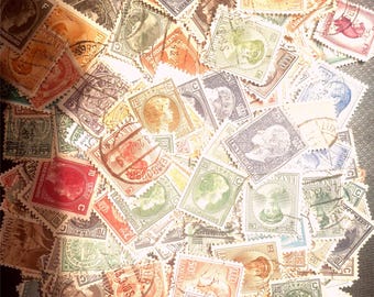 May include: A collection of vintage postage stamps in various colors, including red, green, orange, and purple. The stamps feature portraits and other designs, with some showing the word "Luxembourg".
