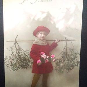 Carte postale française du Nouvel An "Bonne Année" des années 1920, utilisée. Fille en belle robe et chapeau d’époque. Avec bouquet de fleurs et gui