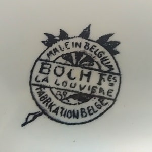 May include: Black and white logo on a white background. The logo reads "Made in Belgium Boch F&egrave;s La Louvi&egrave;re Fabrication Belge".