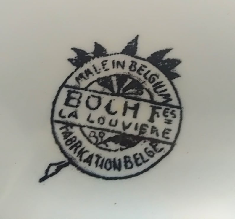 May include: Black and white logo on a white background. The logo reads "Made in Belgium Boch F&egrave;s La Louvi&egrave;re Fabrication Belge".