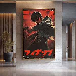 May include: A framed poster featuring a man in a suit holding a gun, set against a red and black background. Japanese text is visible at the bottom. The artwork is displayed in a modern interior setting.