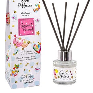 May include: A reed diffuser set, presented in a decorative box. The clear glass bottle has black reeds and a silver cap. The box and bottle are adorned with illustrations and the words "Special Friend" and "Just for you."