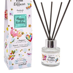 May include: A reed diffuser set with a clear glass bottle and black reeds, alongside a decorative box. The box and bottle are decorated with hearts, stars, and the words "Happy Birthday". The box also says "Handmade in the UK".