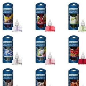 May include: Assortment of ten scented oil diffuser refills in various colors and scents. The refills are packaged in clear plastic bottles with a white label that reads "Yankee Candle ScentPlug Refill Recharge Scented".