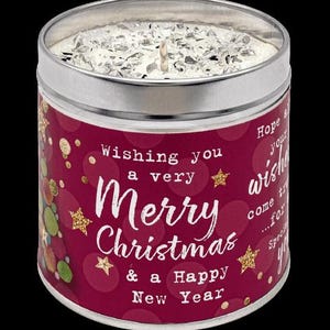 May include: A Christmas candle in a silver tin with a burgundy label. The label says "Wishing you a very Merry Christmas & a Happy New Year" with gold stars. The candle has a surface covered in silver glitter. A seasonal gift.