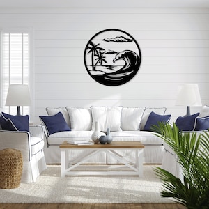 May include: Black metal wall art depicting a wave crashing on a beach with palm trees in the background. The art is circular and has a white background.