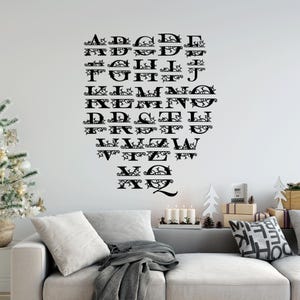 May include: Black vinyl wall decal featuring the alphabet in a decorative font with a vine design. Each letter is framed with a vine design.
