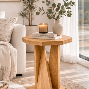 Light oak small wooden side table, narrow accent table by sofa, modern farmhouse end table styling with decor.