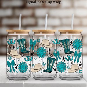 May include: Three clear glass cups with wooden lids and straws. Each cup features a turquoise cowboy boot, hat, horseshoe, and floral design. The text "Digital 16 Oz Cup Wrap" is at the top.