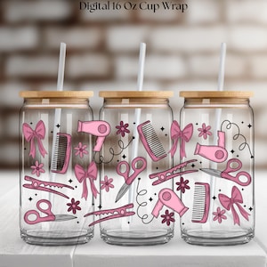 May include: Three glass tumblers with bamboo lids and straws. Each has a pink design of hairdressing tools, including scissors, combs, and bows. The text "Digital 16 Oz Cup Wrap" is at the top.