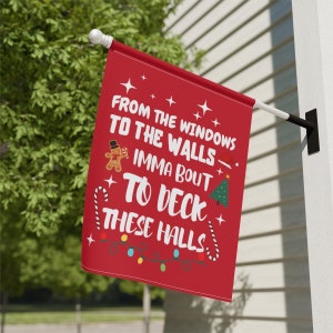 May include: Red Christmas flag with white text that reads "From the windows to the walls imma bout to deck these halls". The flag also features a gingerbread man, a candy cane, a Christmas tree, and a string of Christmas lights.