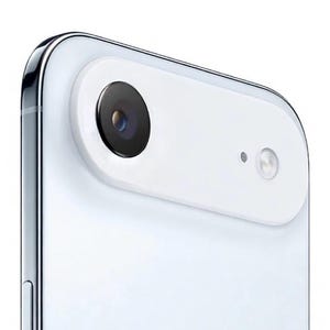 May include: Close-up of a white smartphone with a black camera lens and a smaller circular lens. The phone has a silver metallic frame and a white back. The camera module is a white oval shape.