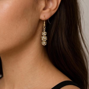 May include: A set of three ceramic mugs with a speckled, matte finish. The mugs are in shades of cream, light gray, and dark gray. Each mug has a simple, minimalist design, perfect for coffee or tea.