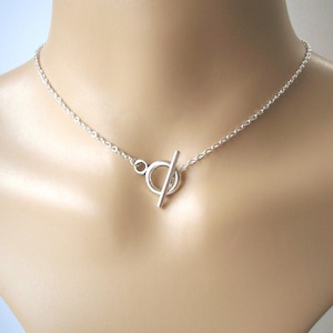 T-halsband, silverfärgat cirkelhalsband, tjockt litet framtillknäppning med togglespänne och choker på försilvrad kabelkedja i rostfritt stål