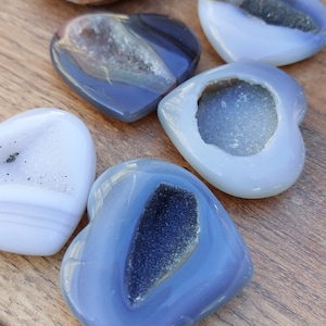 May include: Five heart-shaped agate stones with a variety of colours and patterns. The stones are smooth and polished, with a natural, organic look.