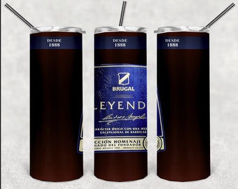 May include: Three stainless steel tumblers with a dark brown exterior. The center tumbler features a blue and gold label with the text "BRUGAL LEYEND" and a signature. The label also includes the text "DESDE 1888" at the top and "CARÁCTER ÚNICO CON UNA MEZ EXCEPCIONAL DE BARRICAS" and "CCIÓN HOMENAJE GADO DEL FUNDADOR" at the bottom.