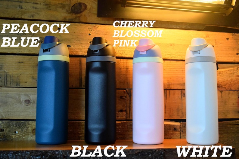 May include: Four insulated water bottles in peacock blue, black, cherry blossom pink, and white. Each bottle has a matching colored lid with a contrasting accent color. The text "PEACOCK BLUE", "BLACK", "CHERRY BLOSSOM PINK", and "WHITE" are displayed.