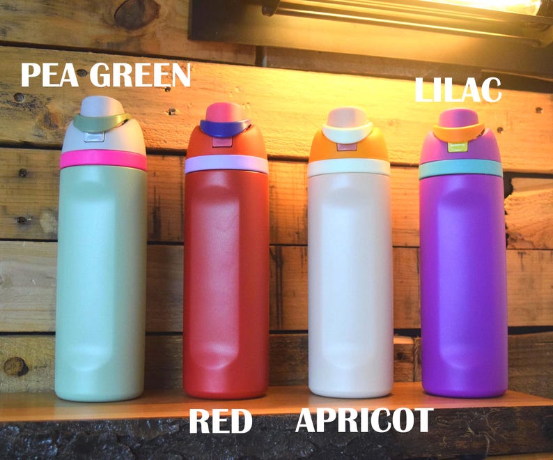 May include: Four colorful water bottles in pea green, red, apricot, and lilac. Each bottle has a contrasting colored lid and a matching colored band. The bottles are displayed on a wooden surface with the colors labeled.