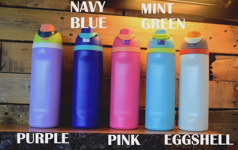 May include: Five colorful water bottles in purple, navy blue, pink, mint green, and eggshell. Each bottle has a contrasting colored lid and the names of the colors are written above the bottles. The bottles are displayed on a wooden surface.