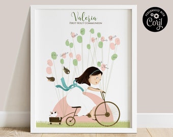 May include: A white framed print with a personalized illustration of a girl riding a bicycle with balloons. The balloons have names written on them. The text "Valeria First Holy Communion" is at the top of the print. The print is personalized with "Corjl".