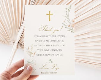 May include: A white thank you card with gold lettering and a floral design. The text reads "Thank you! For adding to the joyous spirit of my communion day with the blessings of your love, generous gifts & prayers for me. Love, Vega September 21st, 2024."