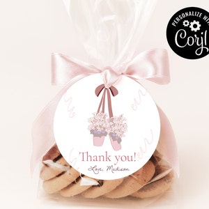 May include: Pink and white favor bag with a pink ribbon and a round tag with a pink ballet shoe illustration and the text "Thank you! Love, Madison".