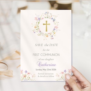 Pode incluir: Um cartão de convite creme com detalhes florais e uma cruz dourada. O texto diz "SAVE the DATE for the FIRST COMMUNION of our daughter Catherine Sunday, May 23rd 2026". Convite formal e detalhes a seguir.