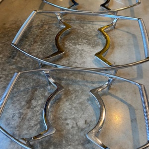 May include: Three silver metal serving trays with a wavy design. The trays are stacked on top of each other.