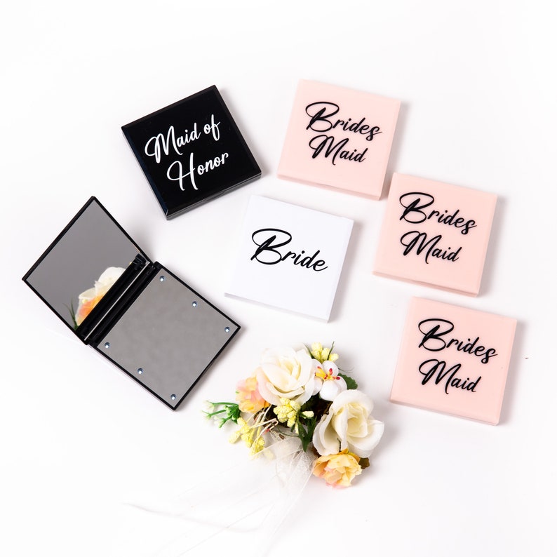May include: A set of five small, square, decorative boxes with different titles. The boxes are black, white, and pink. The titles are "Maid of Honor", "Bride", and "Bridesmaid".