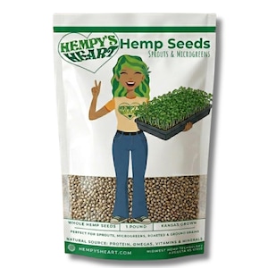 May include: A white stand-up pouch of Hempy's Heart Hemp Seeds. The label features a cartoon character with green hair holding a tray of microgreens, text reading Hempy's Heart Hemp Seeds Sprouts & Microgreens, and a window showing 1 pound of seeds.