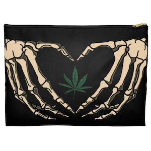May include: Black canvas zippered pouch with a graphic of two skeletal hands forming a heart shape with a green marijuana leaf inside.