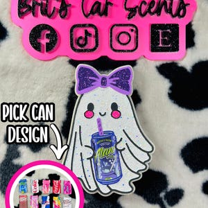 May include: A glittery white ghost ornament with a purple bow, holding a blue Alani Nu can. Above, a pink sign reads Brit's Car Scents with social media icons. Below, a circular graphic displays various miniature soda can designs with the text PICK CAN DESIGN.
