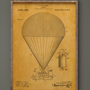 May include: A framed vintage patent print of a hot air balloon, with detailed technical drawings in sepia tones. The print includes text such as "Patented May 13, 1913" and "T.G. Lowe". The artwork is displayed in a wooden frame.