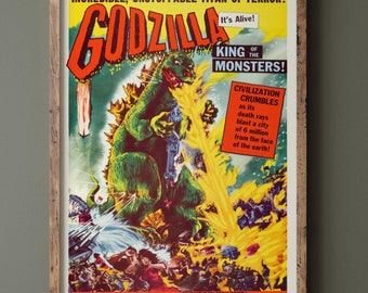 May include: A vintage movie poster for the 1954 film "Godzilla" featuring a green monster with a fiery background. The poster text reads "Incredible, Unstoppable Titan of Terror! Godzilla It's Alive! King of the Monsters! Civilization Crumbles as its death rays blast a city of 6 million from the face of the earth!" and "Mightiest Monster! Mightiest Melodrama of them all!"