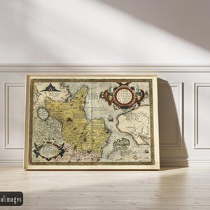 May include: A framed antique map with a beige border, depicting a detailed geographical layout. The map features intricate illustrations, including ships and decorative cartouches. The color palette includes beige, brown, and touches of blue and red. The map is leaning against a white wall.