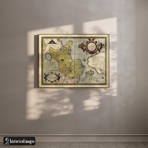May include: A framed antique map with a detailed depiction of a historical region. The map features a cream-colored background with intricate illustrations in shades of yellow, brown, and blue. The frame is a warm gold color, adding to the vintage aesthetic.