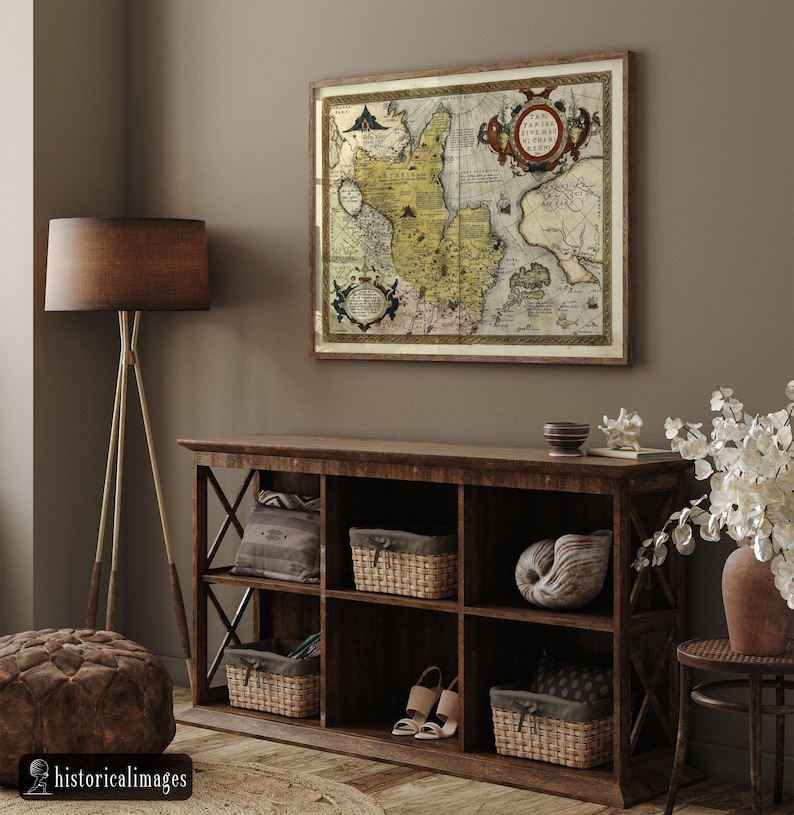 May include: A framed antique map with a detailed cartographic design in shades of yellow, brown, and beige hangs above a dark wooden cabinet. The cabinet features woven baskets, decorative items, and a pair of sandals. A floor lamp and ottoman are also visible.
